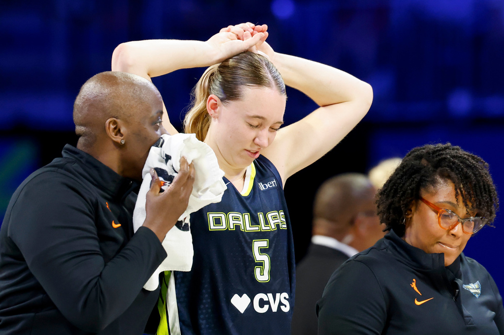 Dallas Wings guard Paige Bueckers (5) holds her head after a collision with Los Angeles Sparks forward Nneka Ogwumike during the second half of a WNBA basketball game, Sunday, July 19, 2026, in Arlington, Texas. (Elías Valverde II/The Dallas Morning News via AP)