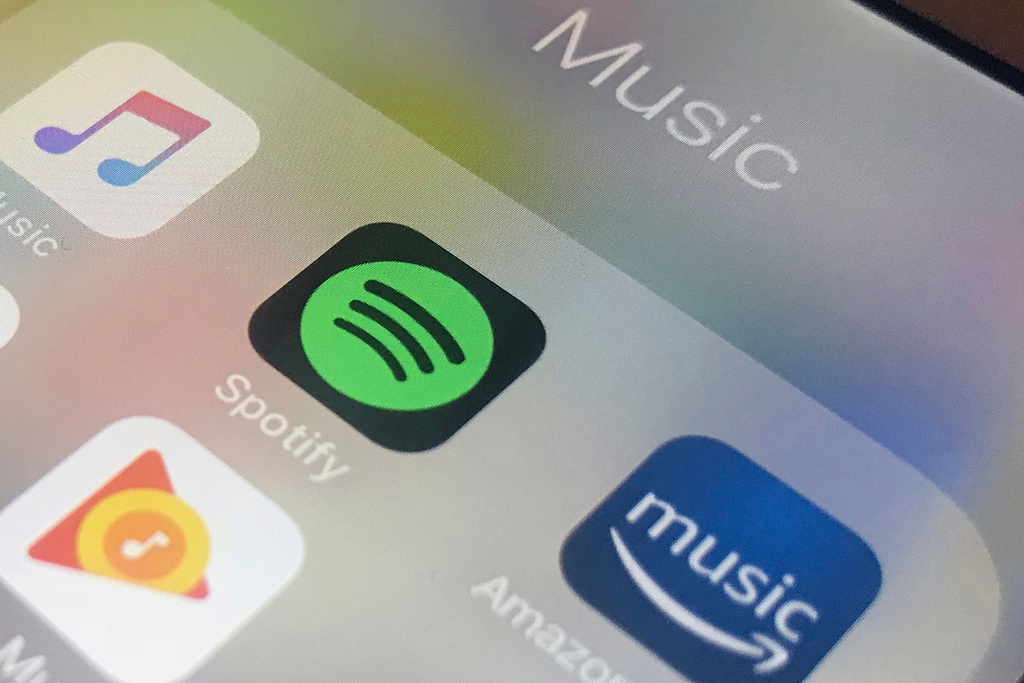 FILE - This Sunday, Jan. 28, 2018, photo shows music streaming apps clockwise from top left, Apple, Spotify, Amazon, Pandora and Google on an iPhone in New York. (AP Photo/Jenny Kane, File)