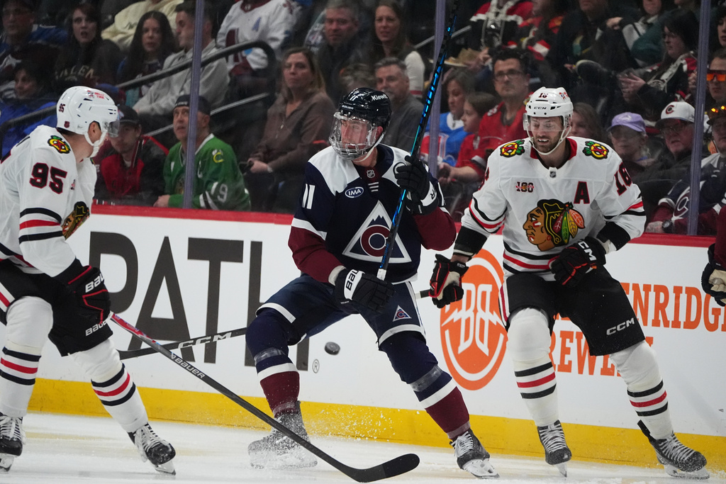 Colorado Avalanche center Brock Nelson, center, loses control of the puck as Chicago Blackhawks right wing Ilya Mikheyev, left, and center Jason Dickinson defend in the second period of an NHL hockey game Saturday, Feb. 28, 2026, in Denver. (AP Photo/David Zalubowski)