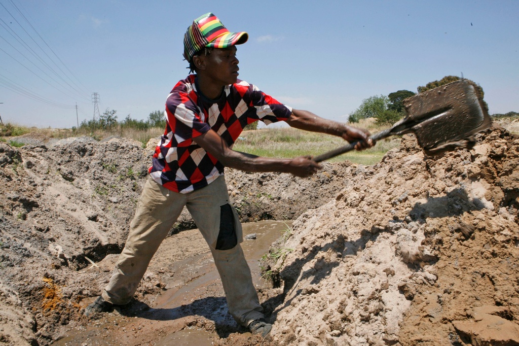 FILE - Siphelele Dyasi digs at an abandoned gold mine in Roodepoort, South Africa, Nov. 2, 2012. (AP Photo/Themba Hadebe, File)