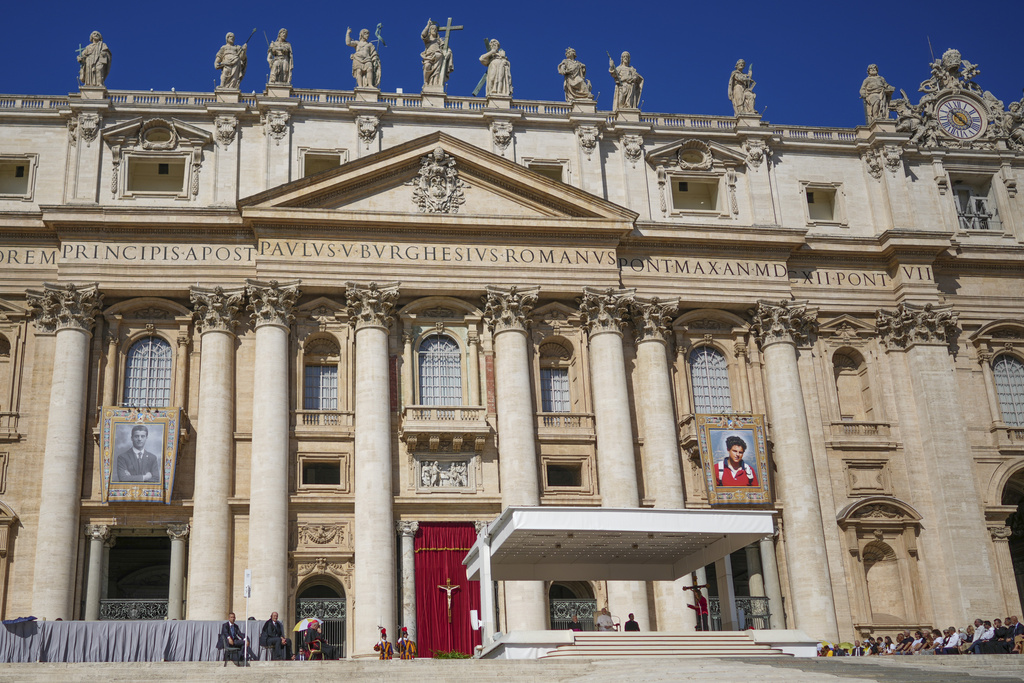 Pope Leo XIV holds an open-air jubiliar audience in St. Peter's Square at the Vatican, Saturday, Sept. 6, 2025, a day ahead of the canonization of Carlo Acutis who's portrait is hanging at right, and Pier Giorgio Frazzati, portrait at left. (AP Photo/Andrew Medichini)