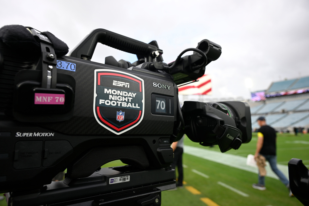 FILE - An ESPN Monday Night Football logo is viewed on a broadcast camera before an NFL football game between the Jacksonville Jaguars and the Kansas City Chiefs, Monday, Oct. 6, 2025, in Jacksonville, Fla. (AP Photo/Phelan M. Ebenhack, File)
