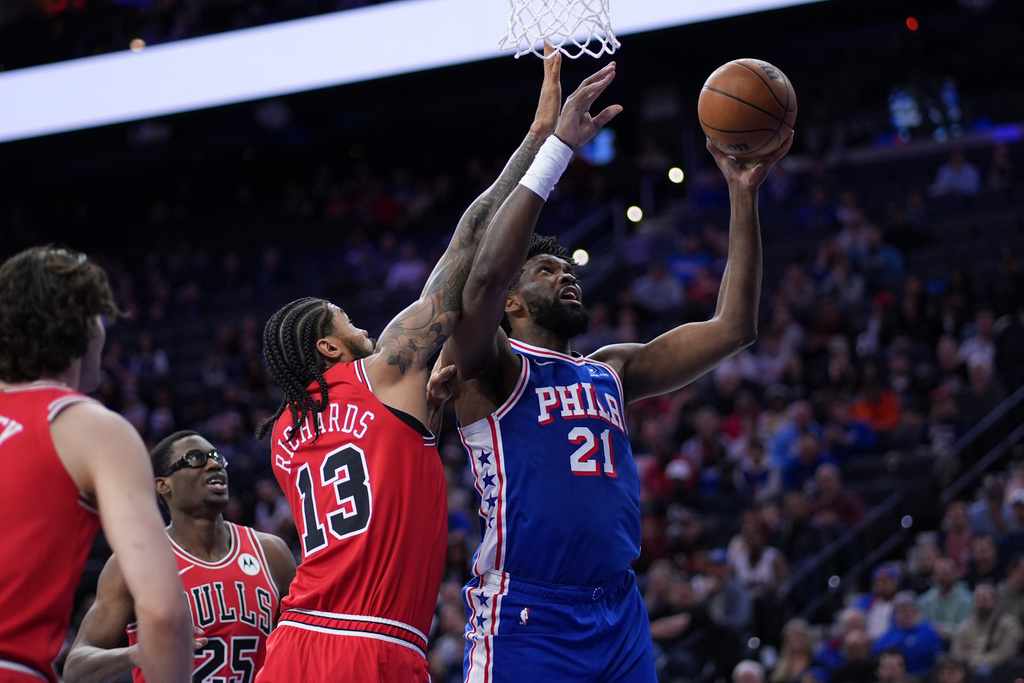 Philadelphia 76ers' Joel Embiid (21) goes up for a shot against Chicago Bulls' Nick Richards (13) during the first half of an NBA basketball game Wednesday, March 25, 2026, in Philadelphia. (AP Photo/Matt Slocum)