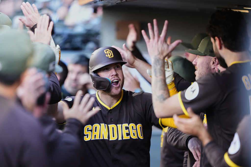 San Diego Padres' Gavin Sheets celebrates in the dugout after hitting a two-run home run against the Seattle Mariners during the sixth inning of a baseball game, Sunday, May 17, 2026, in Seattle. (AP Photo/Lindsey Wasson)