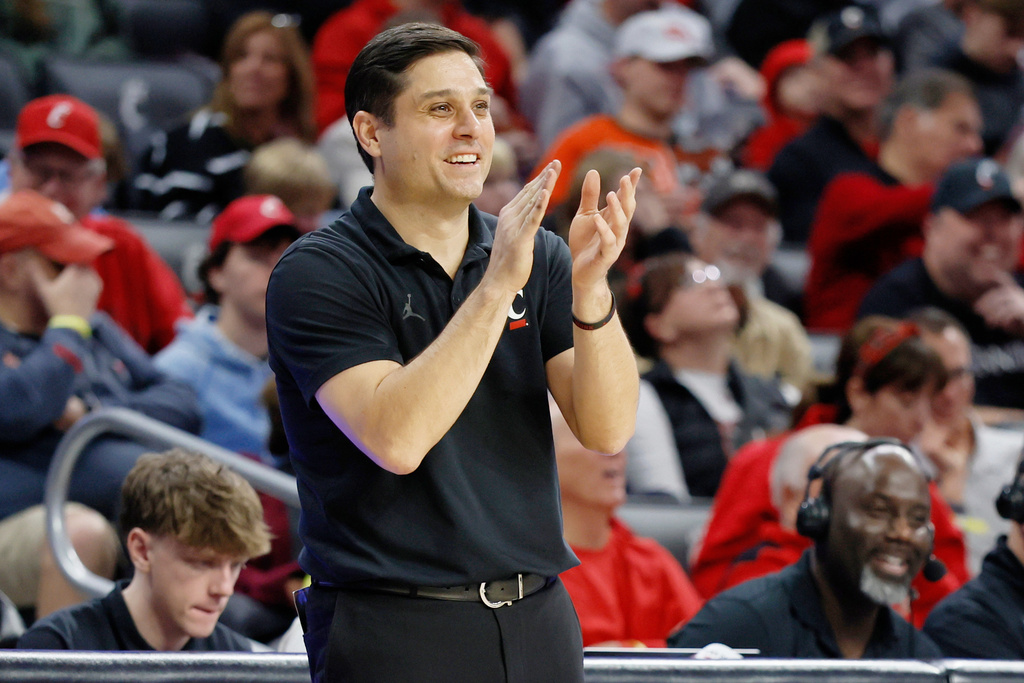 FILE - Cincinnati head coach Wes Miller claps for his team during the second half of an NCAA college basketball game against Grambling State, Sunday, Dec. 22, 2024, in Cincinnati. (AP Photo/Jay LaPrete, File)