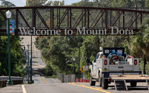A vehicle is seen on a washed out section of Donnelly Street in Mount Dora, Fla. after torrential rains last night, on Monday, Oct. 27, 2025. (Ricardo Ramirez Buxeda/Orlando Sentinel via AP) A vehicle is seen on a washed out section of Donnelly Street in Mount Dora, Fla. after torrential rains last night, on Monday, Oct. 27, 2025. (Ricardo Ramirez Buxeda/Orlando Sentinel via AP)