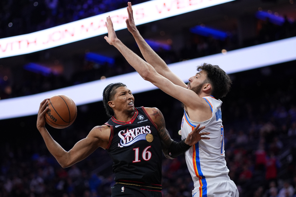 Philadelphia 76ers' Marjon Beauchamp, left, goes up for a shot against Oklahoma City Thunder's Chet Holmgren during the first half of an NBA basketball game Monday, March 23, 2026, in Philadelphia. (AP Photo/Matt Slocum)