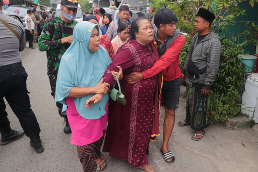 A woman is assisted to walk away after a building collapsed at an Islamic boarding school in Sidoarjo, East Java, Indonesia, Tuesday, Sept. 30, 2025. (AP Photo/Trisnadi) A woman is assisted to walk away after a building collapsed at an Islamic boarding school in Sidoarjo, East Java, Indonesia, Tuesday, Sept. 30, 2025. (AP Photo/Trisnadi)
