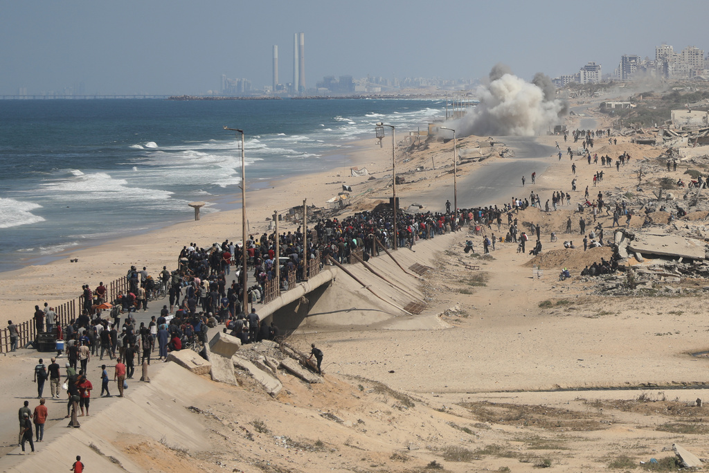 Displaced Palestinians walk along the coastal road near Wadi Gaza in the central Gaza Strip, moving toward northern Gaza, Friday, Oct. 10, 2025, after Israel and Hamas have agreed to a pause in their war and the release of the remaining hostages. (AP Photo/Yousef Al Zanoun)