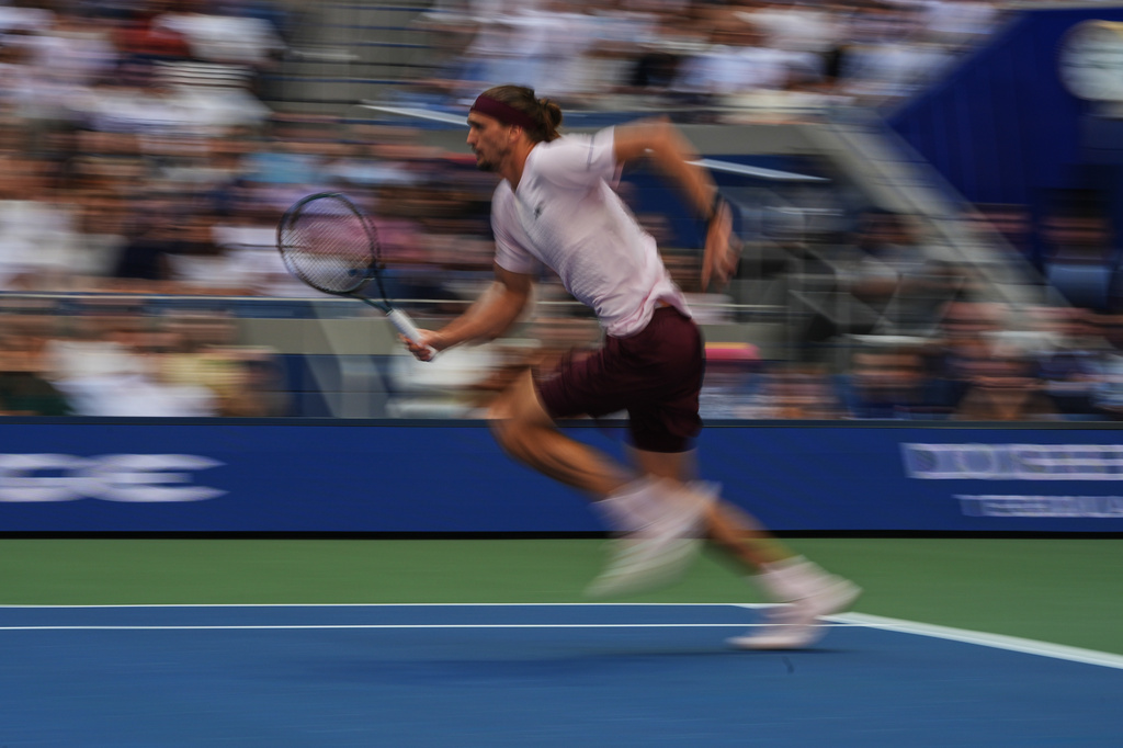 Alexander Zverev, of Germany, runs to the net to return the ball to Ben Shelton, of the United States, during the men's singles final of the U.S. Open tennis championships Sunday, Sept. 13, 2026, in New York. (AP Photo/Frank Franklin II)
