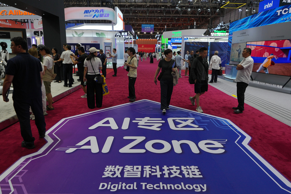 Visitors tour the exhibition booths operated with Artificial Intelligence (AI) at the China International Supply Chain Expo in Beijing on June 25, 2026. (AP Photo/Andy Wong)
