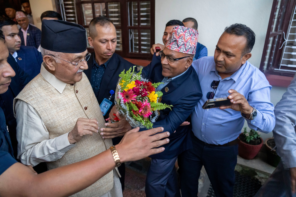 FILE - Khadga Prasad Oli, left, the chairman of the Communist Party of Nepal leaves his residence to meet his supporters after being appointed as Prime Minister, in Kathmandu, Nepal, Sunday, July 14, 2024. (AP Photo/Niranjan Shrestha,File)