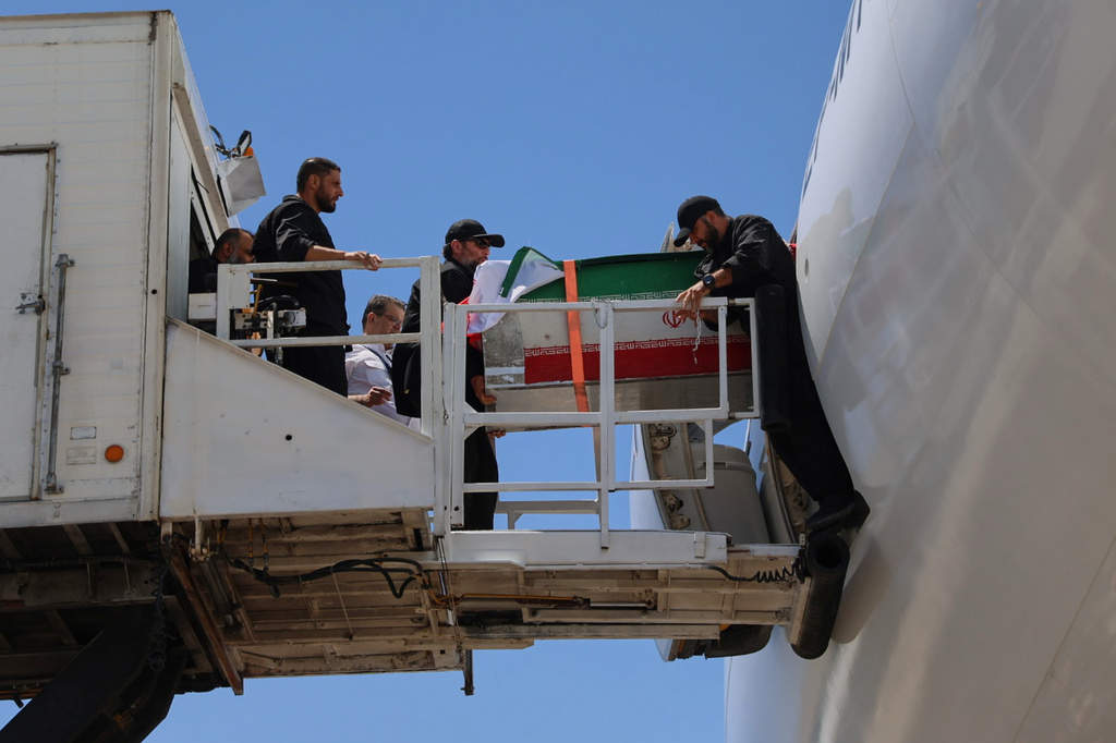 The coffin of the late Iranian Supreme Leader Ayatollah Ali Khamenei is carried from a plane at Hasheminejad International Airport after arriving from Iraq for the final stage of his dayslong funeral ceremonies in Mashhad, northeastern Iran, Thursday, July 9, 2026. (Mohammad Hasan Salavati/Shahraranews via AP)