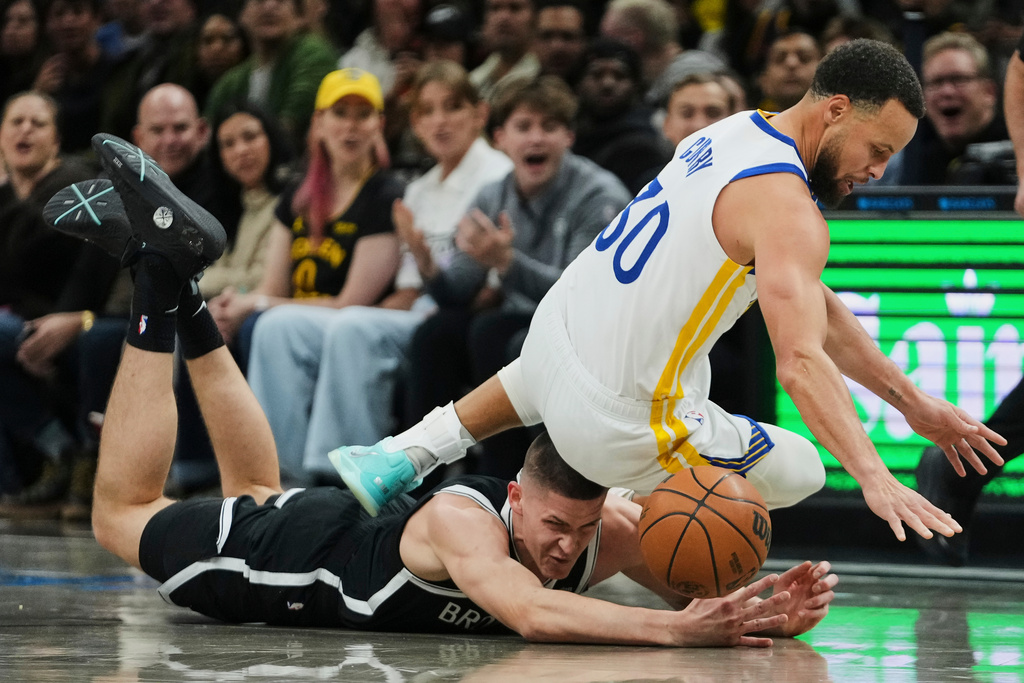Brooklyn Nets' Egor Demin (8) fights for control of the ball with Golden State Warriors' Stephen Curry (30) during the first half of an NBA basketball game Monday, Dec. 29, 2025, in New York. (AP Photo/Frank Franklin II)