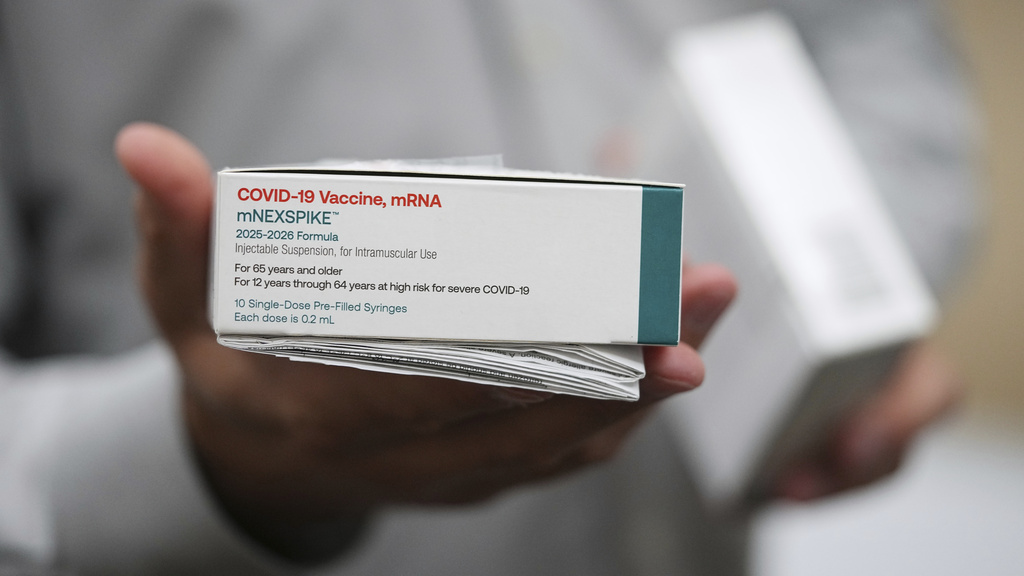 Co-owner Marc Ost at Eric's Rx Shoppe holds a box of COVID-19 vaccines as he unpacks a shipment in Horsham, Pa., Tuesday, Sept. 2, 2025. (AP Photo/Matt Rourke)