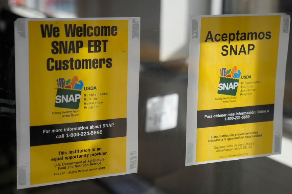 Signage showing that USDA Supplemental Nutrition Assistance Program (SNAP) is accepted, is displayed at Wild Onion Market, Monday, Oct. 27, 2025, in Chicago. (AP Photo/Erin Hooley)