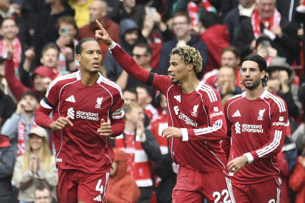 Liverpool's Hugo Ekitike, centre, celebrates after scoring his side's second goal during the English Premier League soccer match between Liverpool and Everton at Anfield stadium in Liverpool, England, Saturday, Sept. 20, 2025. (AP Photo/Rui Vieira)
