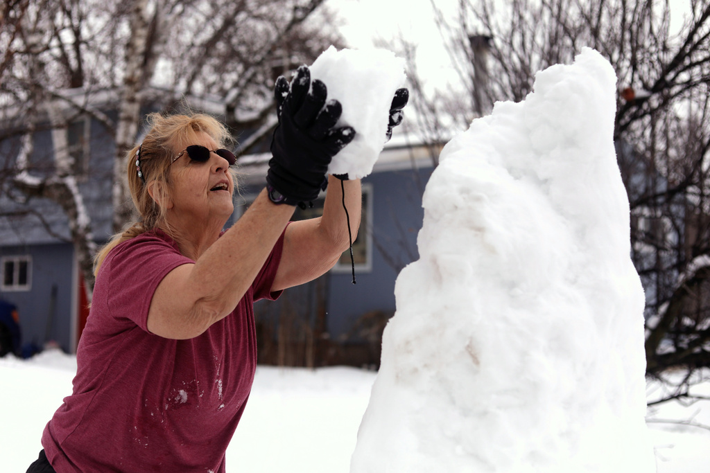 Bus driver Jackie Terry builds a snow sculpture for her students to enjoy along their bus route on Wednesday, Jan. 7, 2026 in Vergennes, Vt. (AP Photo/Amanda Swinhart)