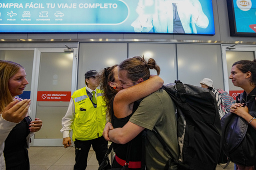 Passenger Diego Valenzuela is embraced by his mother Solange Somerville after he arrived from New Zealand, at the international airport in Santiago, Chile, Tuesday, March 12, 2024. Valenzuela was a passenger on flight LA800 in which at least 50 people were injured Monday by what officials described as a &ldquo;strong movement&rdquo; on the Chilean plane traveling from Sydney to Auckland, New Zealand. (AP Photo/Esteban Felix)