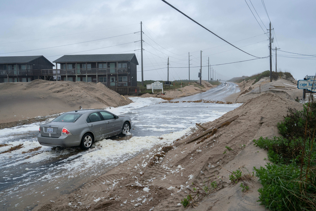Highway 12 is flooded in the midst of a storm, Sunday, Oct. 12, 2025, in Buxton, N.C. (AP Photo/Allison Joyce)