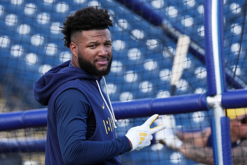 FILE - Milwaukee Brewers' Jackson Chourio gestures during a spring training baseball workout, Feb. 18, 2026, in Phoenix. (AP Photo/Morry Gash, File)