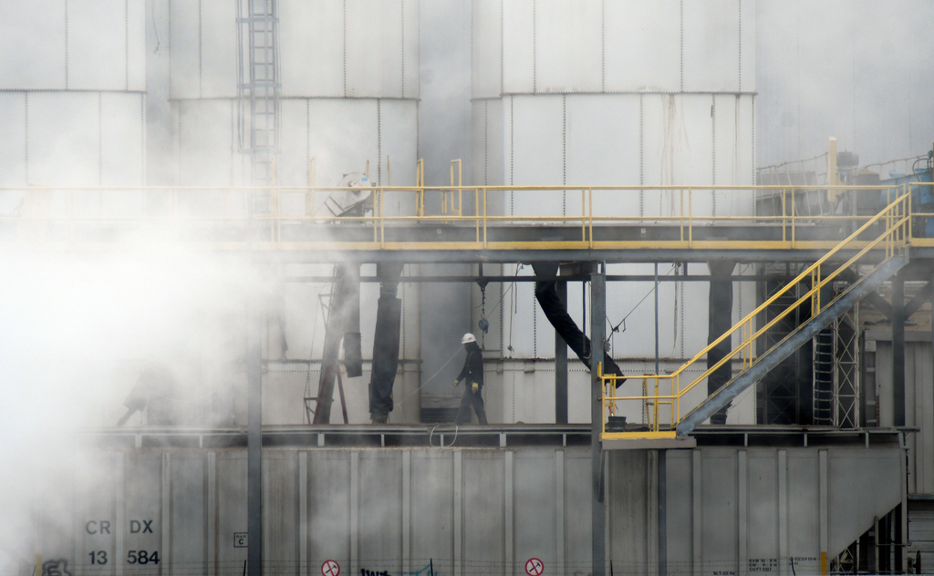 A worker walks through steam coming from the Tyson Foods' beef plant in Lexington, Neb., Thursday, Dec. 4, 2025. (AP Photo/Thomas Peipert)