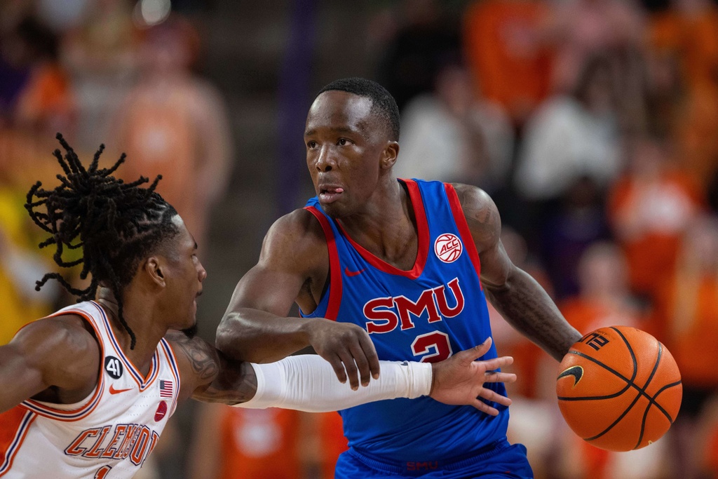 SMU guard Boopie Miller (2) drives on Clemson guard Jestin Porter (1) during the first half of an NCAA college basketball game Wednesday, Jan. 7, 2026, in Clemson, S.C. (AP Photo/Scott Kinser)