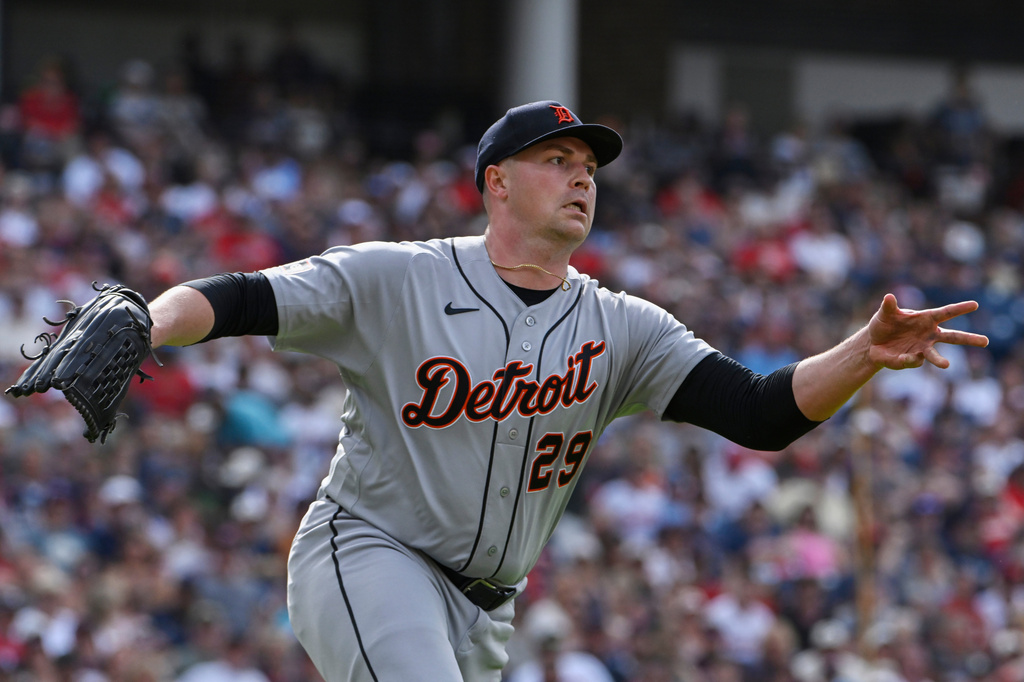 Detroit Tigers starting pitcher Tarik Skubal tosses the ball to first base but not in time to get Cleveland Guardians' Stuart Fairchild out during the fourth inning of a baseball game, Saturday, June 13, 2026, in Cleveland. (AP Photo/Phil Long)