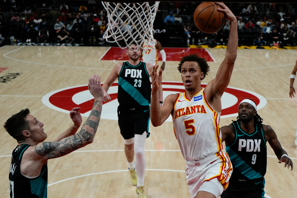 Atlanta Hawks guard Dyson Daniels (5) shoots against Portland Trail Blazers guard Vit Krejci (27) during the first half of an NBA basketball game, Sunday, March 1, 2026, in Atlanta. (AP Photo/Mike Stewart)