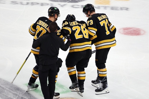 Boston Bruins' Hampus Lindholm (27) and Charlie McAvoy (73) help Elias Lindholm (28) off the ice during the second period of an NHL hockey game against the Buffalo Sabres, Thursday, Oct. 30, 2025, in Boston. (AP Photo/Michael Dwyer) Boston Bruins' Hampus Lindholm (27) and Charlie McAvoy (73) help Elias Lindholm (28) off the ice during the second period of an NHL hockey game against the Buffalo Sabres, Thursday, Oct. 30, 2025, in Boston. (AP Photo/Michael Dwyer)