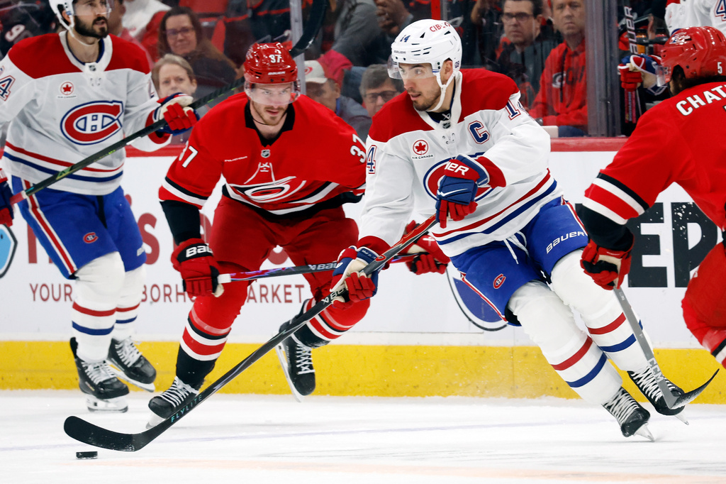 Montréal Canadiens' Nick Suzuki (14) controls the puck against the Montréal Canadiens during the first period of an NHL hockey game in Raleigh, N.C., Sunday, March 29, 2026. (AP Photo/Karl DeBlaker)