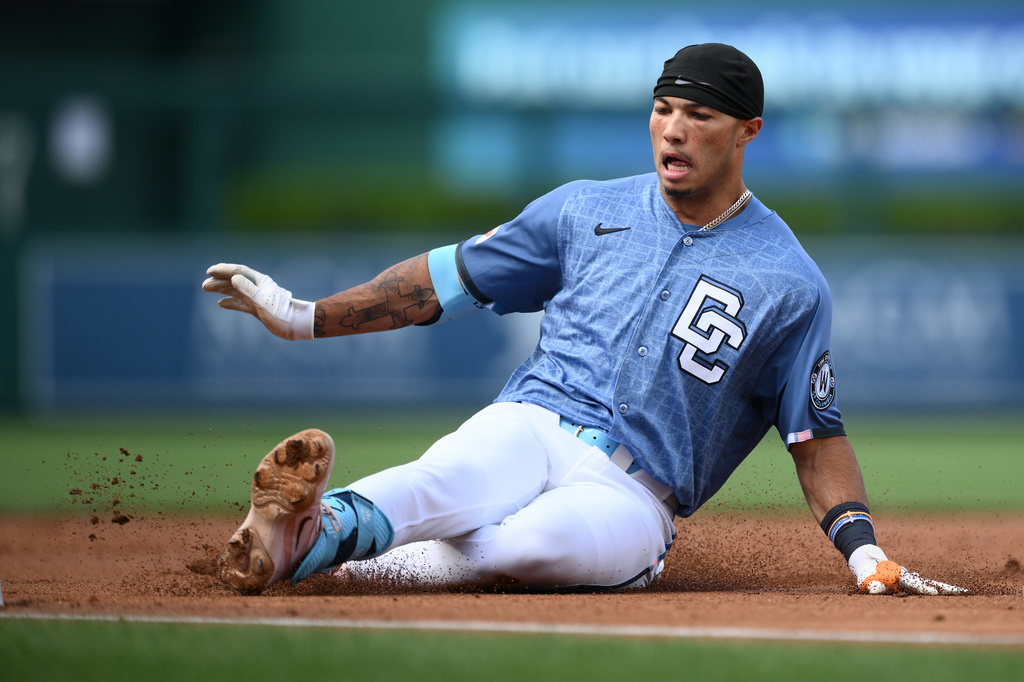 Washington Nationals' Daylen Lile slides to third base on his triple during the first inning of a baseball game against the Seattle Mariners, Saturday, June 13, 2026, in Washington. (AP Photo/Nick Wass)