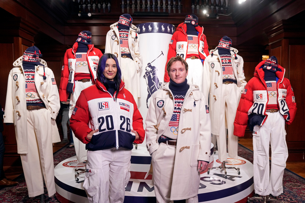 Snowboarders Brenna Huckaby, left, and Red Gerard unveil Ralph Lauren's Team USA closing and opening ceremony uniforms for the 2026 Milan Cortina Winter Olympics at Ralph Lauren headquarters, Wednesday, Dec. 3, 2025, in New York. (Photo by Charles Sykes/Invision/AP)