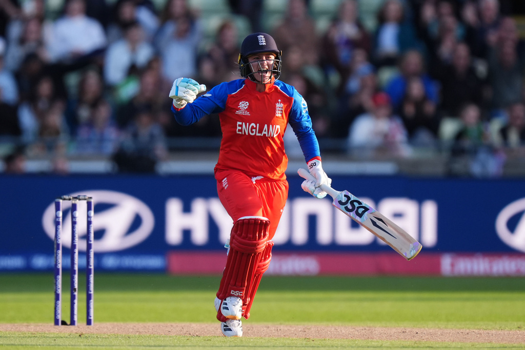 England's Danni Wyatt-Hodge celebrates reaching her century during the ICC Women's T20 World Cup, Group 2 match between England and Sri Lanka, at Edgbaston, Birmingham, England, Friday June 12, 2026. (Mike Egerton/PA via AP)
