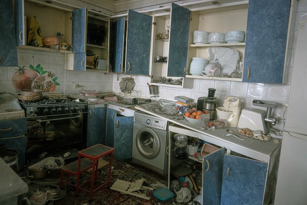 A damaged kitchen is seen in a house that was affected when a nearby residential building was hit in an overnight strike during the U.S.-Israeli military campaign in Tabriz, East Azerbaijan Province, northwestern Iran, Tuesday, March 24, 2026. (AP Photo/Matin Hashemi)