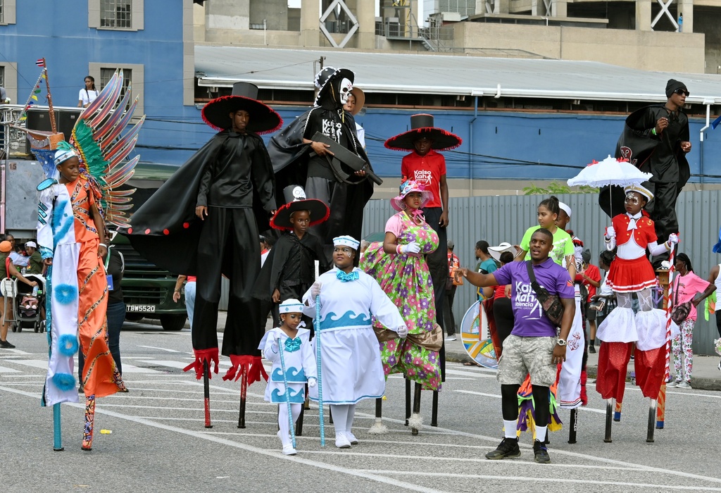 Band leader Joshua Lamorelle, front right, walks with Masqueraders from Kaiso Kah Valencia band before participating in the Junior Carnival Parade of the Bands in Port of Spain, Trinidad and Tobago, Saturday, Feb. 14, 2026. (AP Photo/Robert Taylor)