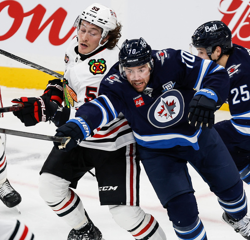 Winnipeg Jets' Tanner Pearson (70) and Chicago Blackhawks' Tyler Bertuzzi (59) go for the puck during second-period NHL hockey game action in Winnipeg, Manitoba, Thursday, Oct. 30, 2025. (John Woods/The Canadian Press via AP) Winnipeg Jets' Tanner Pearson (70) and Chicago Blackhawks' Tyler Bertuzzi (59) go for the puck during second-period NHL hockey game action in Winnipeg, Manitoba, Thursday, Oct. 30, 2025. (John Woods/The Canadian Press via AP)