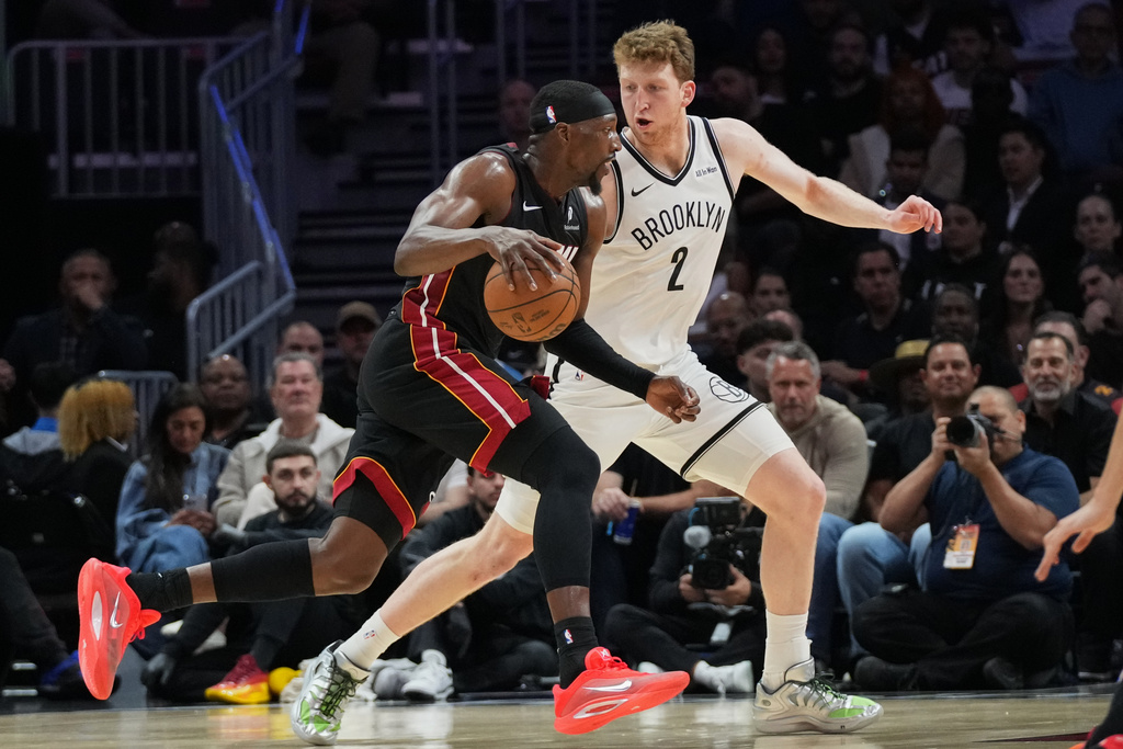 Miami Heat center Bam Adebayo, lifted rives to the basket as Brooklyn Nets forward Ziaire Williams (1) defends during the first half of an NBA basketball game, Tuesday, March 3, 2026, in Miami. (AP Photo/Lynne Sladky)