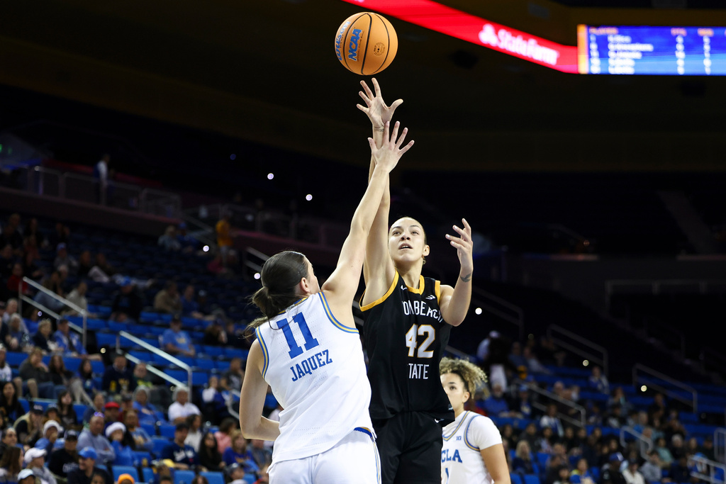 Long Beach State forward Judit Oliva Fernandez (42) shoots against UCLA guard Gabriela Jaquez (11) as guard Kiki Rice, back right, watches during the first half of an NCAA college basketball game, Saturday, Dec. 20, 2025, in Los Angeles. (AP Photo/Jessie Alcheh)