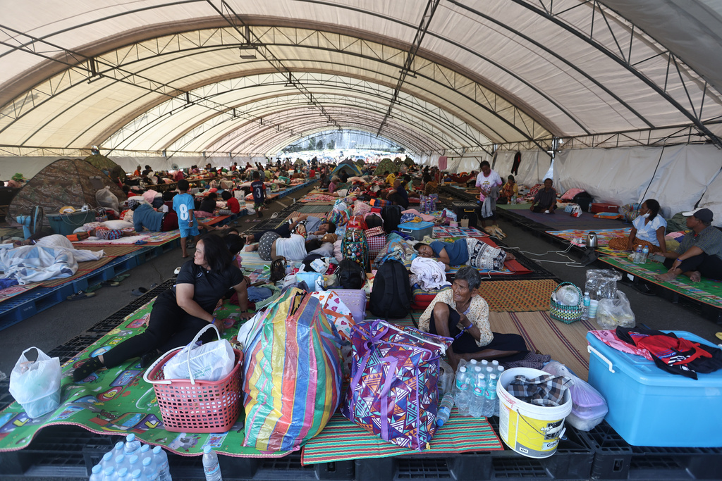 Thai residents who fled homes following clashes between Thai and Cambodian soldiers rest at an evacuation center in Buriram province, Thailand, Monday, Dec. 8, 2025. (AP Photo/Sopa Saelee)
