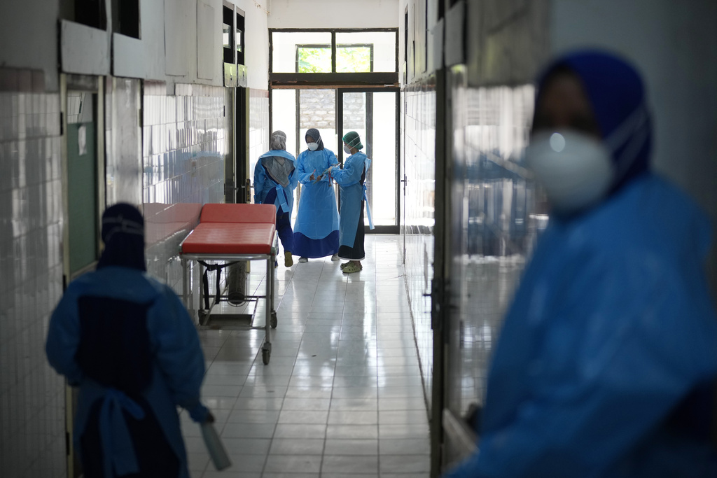 Medical staff stand at an isolation ward for measles patients at Moh Anwar Hospital in Sumenep on Madura Island, Indonesia, Wednesday, Sept. 10, 2025. (AP Photo/Dita Alangkara)