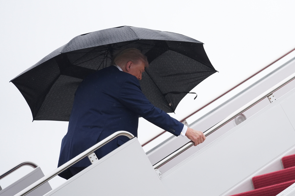 President Donald Trump boards Air Force One, Sunday, Oct. 12, 2025, at Joint Base Andrews, Md.., as he heads to the Middle East. (AP Photo/Evan Vucci)