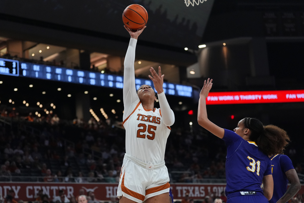 Texas forward Breya Cunningham (25) shoots over Prairie View A&M center Ja'Nya Polk (31) during the second half of an NCAA college basketball game in Austin, Texas, Sunday, Dec. 7, 2025. (AP Photo/Eric Gay)