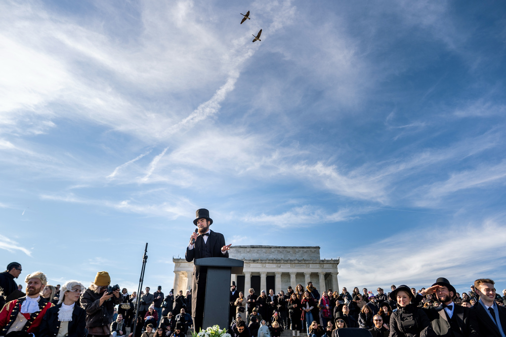 A man dressed as former President Abraham Lincoln speaks at a mock funeral for the penny, which was discontinued earlier this year, Saturday, Dec. 20, 2025, in front of the Lincoln Memorial in Washington. (AP Photo/Julia Demaree Nikhinson)