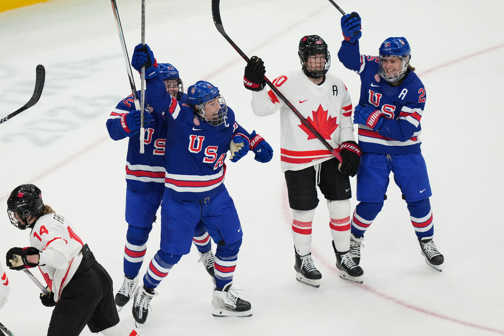 United States' Hilary Knight, center, celebrates after scoring a goal against Canada during the third period of the women's ice hockey gold medal game at the 2026 Winter Olympics, in Milan, Italy, Thursday, Feb. 19, 2026. (AP Photo/Carolyn Kaster)