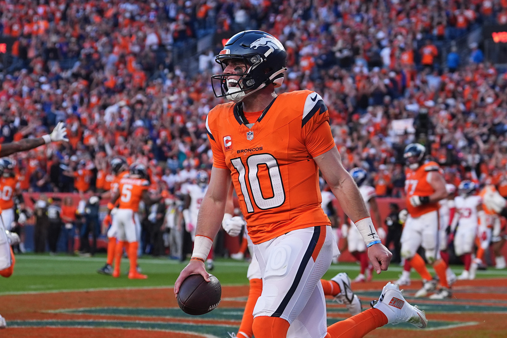 Denver Broncos quarterback Bo Nix (10) celebrates after scoring against the New York Giants during the second half of an NFL football game in Denver, Sunday, Oct. 19, 2025. (AP Photo/David Zalubowski)
