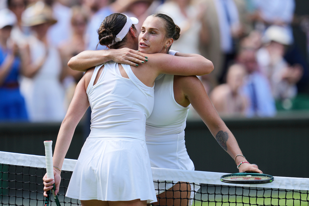 FILE - Belarus' Aryna Sabalenka, right, embraces United States' Amanda Anisimova after losing in a women's singles semifinal match at the Wimbledon Tennis Championships in London, Thursday, July 10, 2025. (AP Photo/Kin Cheung, File)