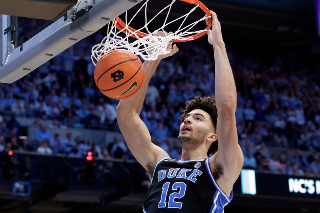 FILE - Duke forward Cameron Boozer dunks during the second half in an NCAA college basketball game against North Carolina, Saturday, Feb. 7, 2026, in Chapel Hill, N.C. (AP Photo/Chris Seward, File)