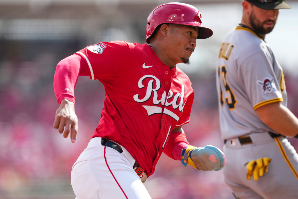 Pittsburgh Pirates third baseman Jared Triolo (19) looks on as Cincinnati Reds' Noelvi Marte rounds third base and scores on a single hit by Gavin Lux during the fifth inning of a baseball game, Thursday, Sept. 25, 2025, in Cincinnati. (AP Photo/Jeff Dean)