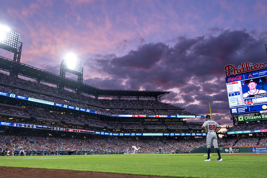 Philadelphia Phillies starting pitcher Jesus Luzardo, center, delivers to Atlanta Braves' Sean Murphy, left, during the third inning of a baseball game, Sunday, Aug. 31, 2025, in Philadelphia. (AP Photo/Chris Szagola)